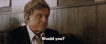 A man wearing a suit and tie saying &quot;Would you?&quot;