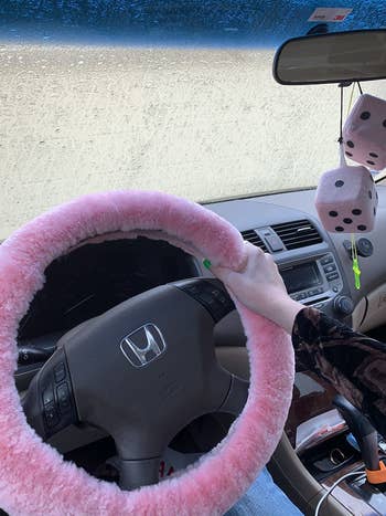 reviewer photo of the pink cover on steering wheel