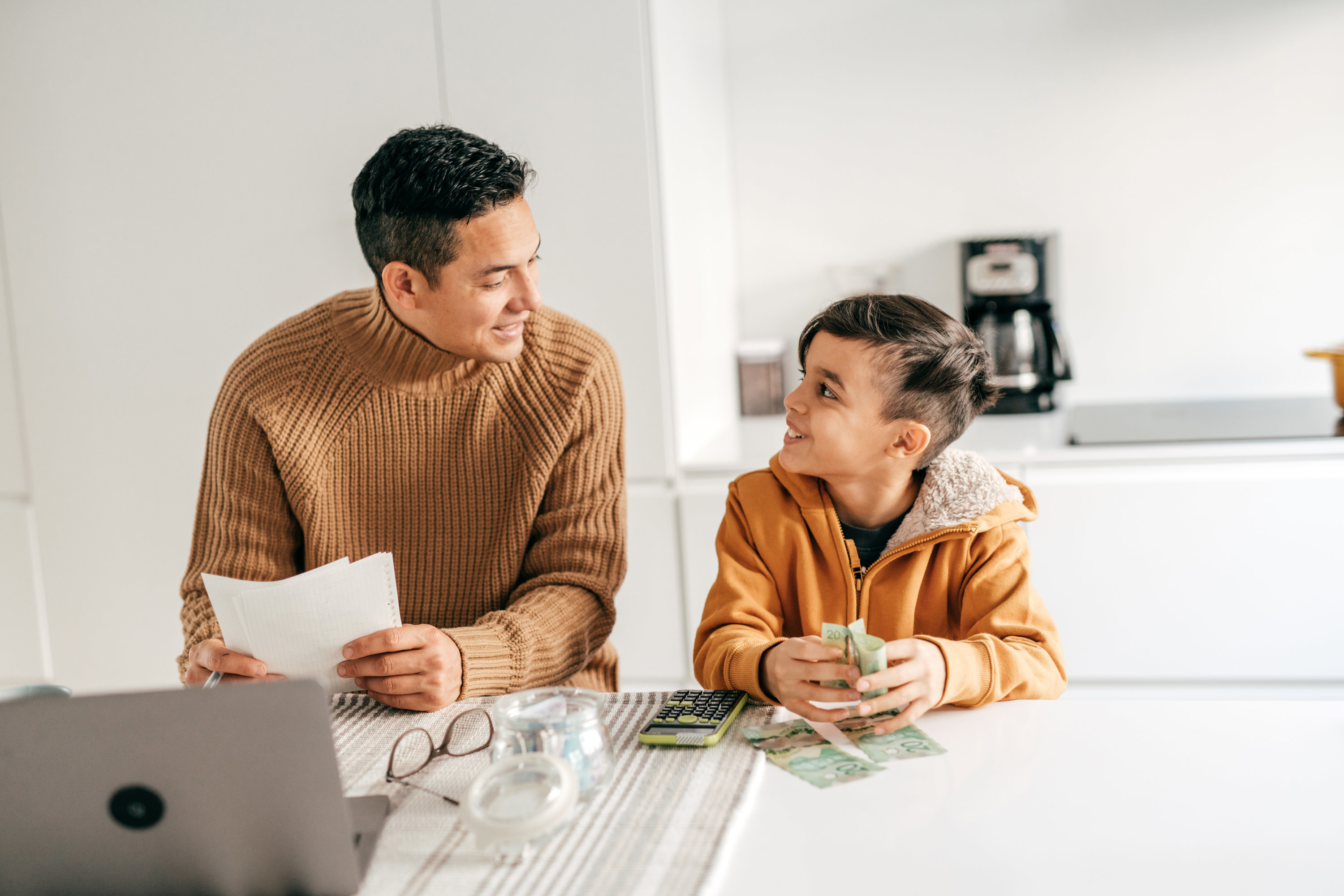 Man talking with his son about money