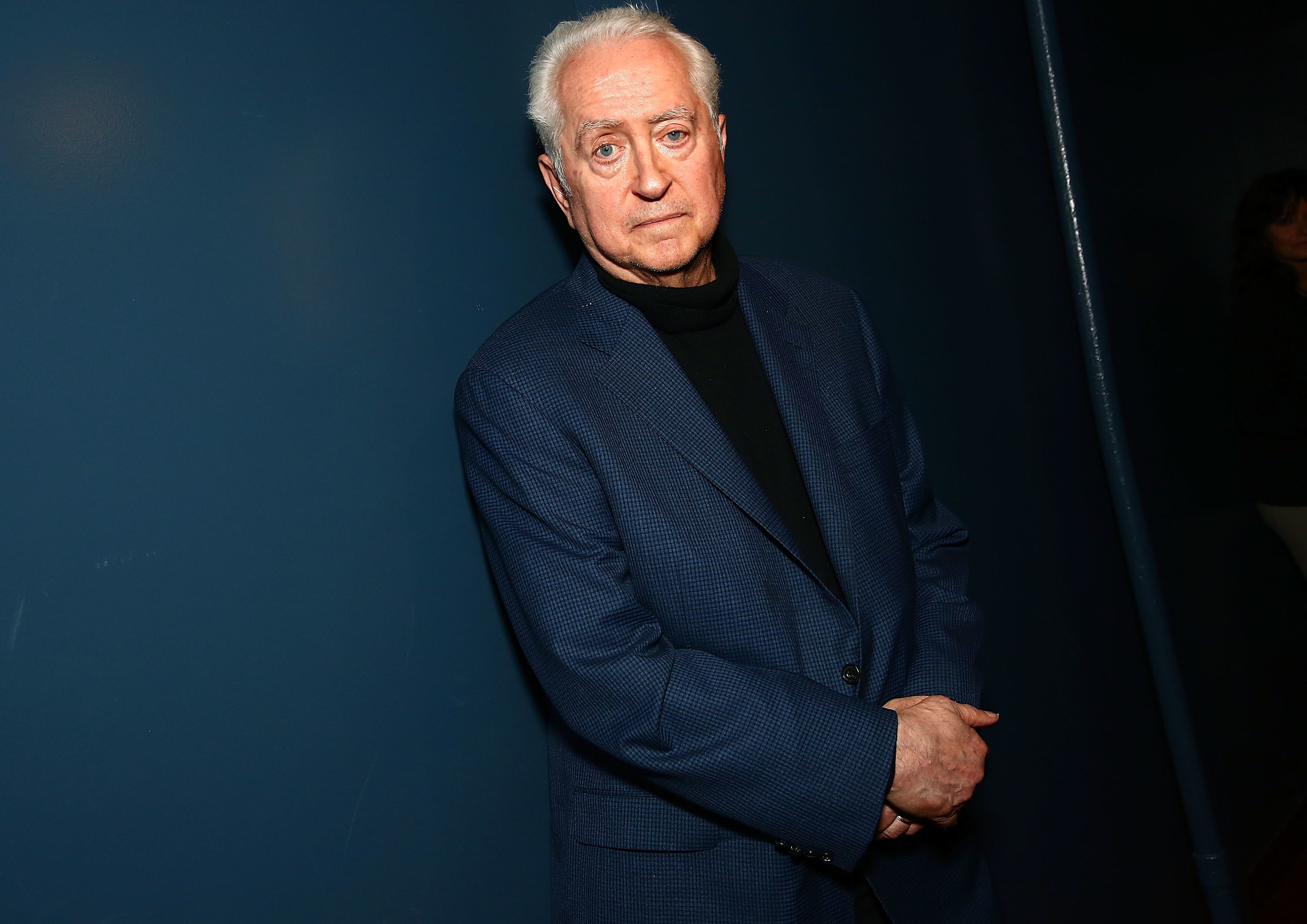 Robert Downey Sr in a suit looking at the camera