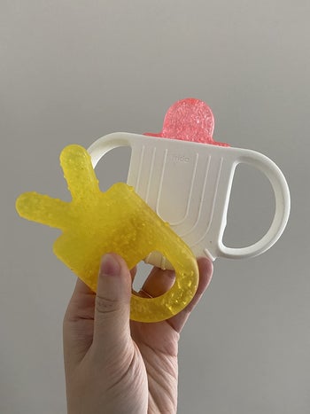 a reviewer holding the teething toys