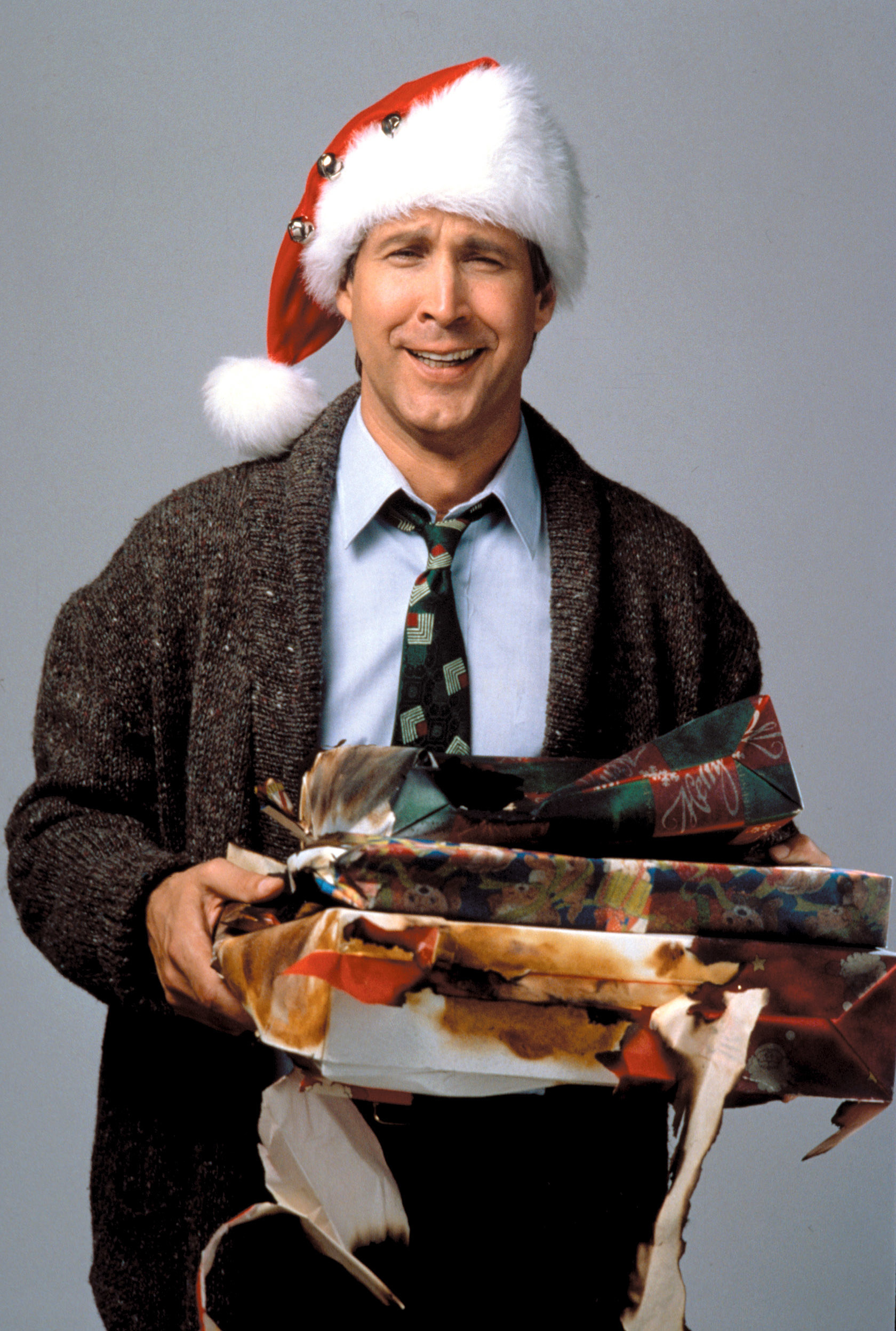 Chevy Chase holding burnt Christmas presents