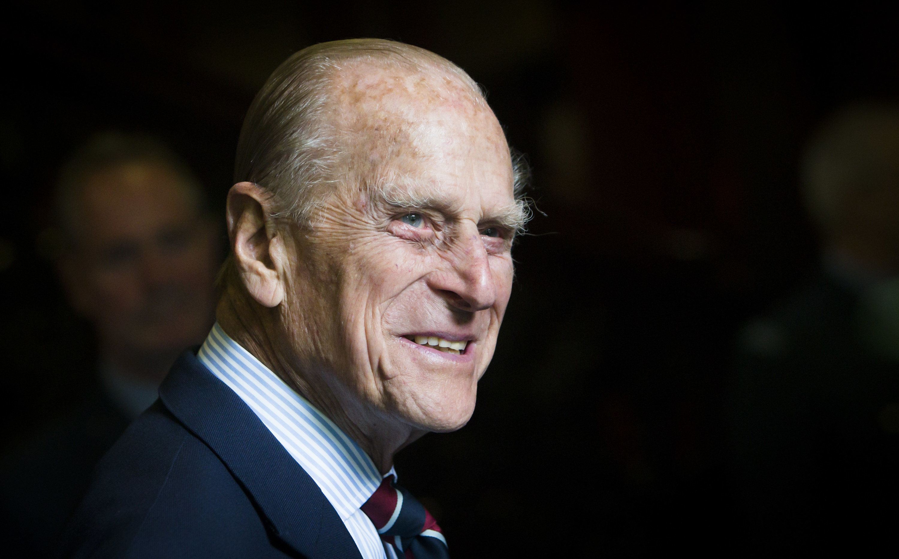 Prince Philip smiling in a suit and tie