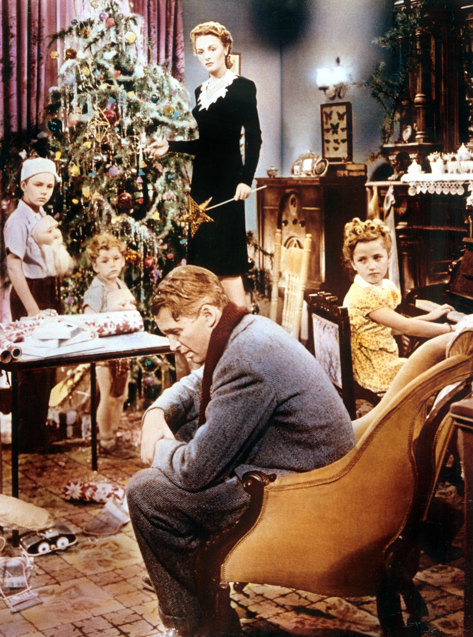 the family gathered around the christmas tree