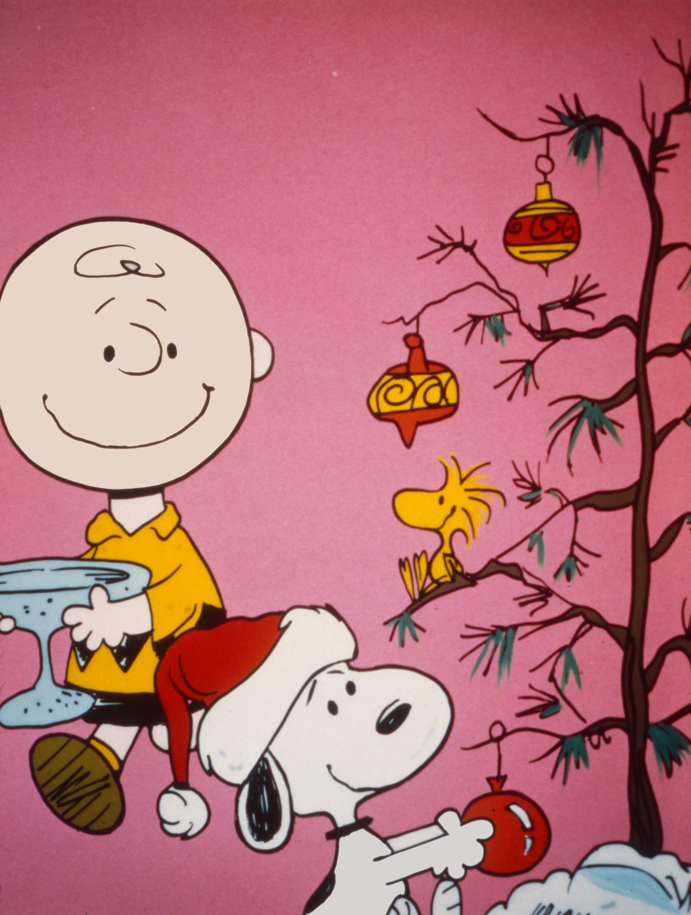 Snoopy and Charlie decorating their Christmas tree