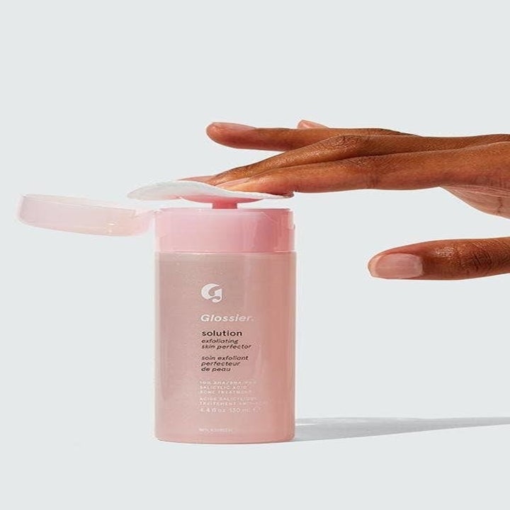 The solution in a pink bottle with a push down pump