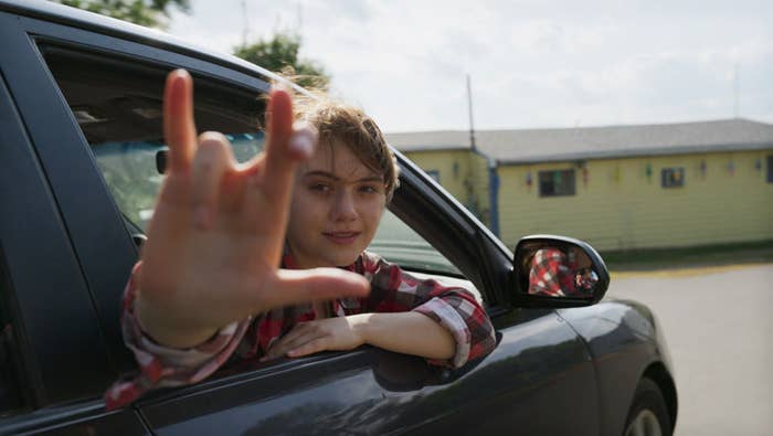 A still from Coda of Ruby signing her family's special sign for "I love you" out of a car window