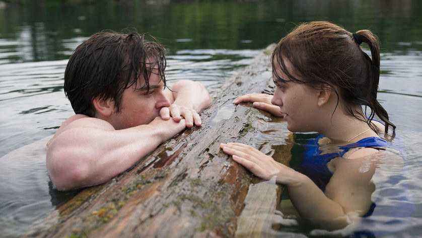 a still of Ruby and Miles swimming in the lake and looking into each others eyes in CODA