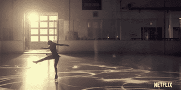 a figure skater spinning on an empty ice rink