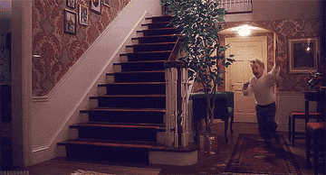 mcaulay culkin running through a house in home alone