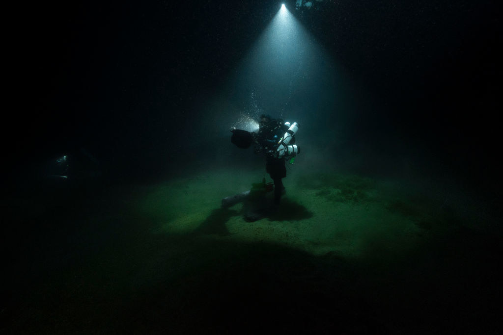 At 111m depth, biologist diver Gilles Siu is taking water samples