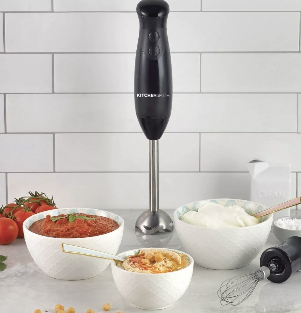 The black immersion blender has a black handle with two buttons and the words &quot;KITCHENSMITH&quot; and a long silver shaft