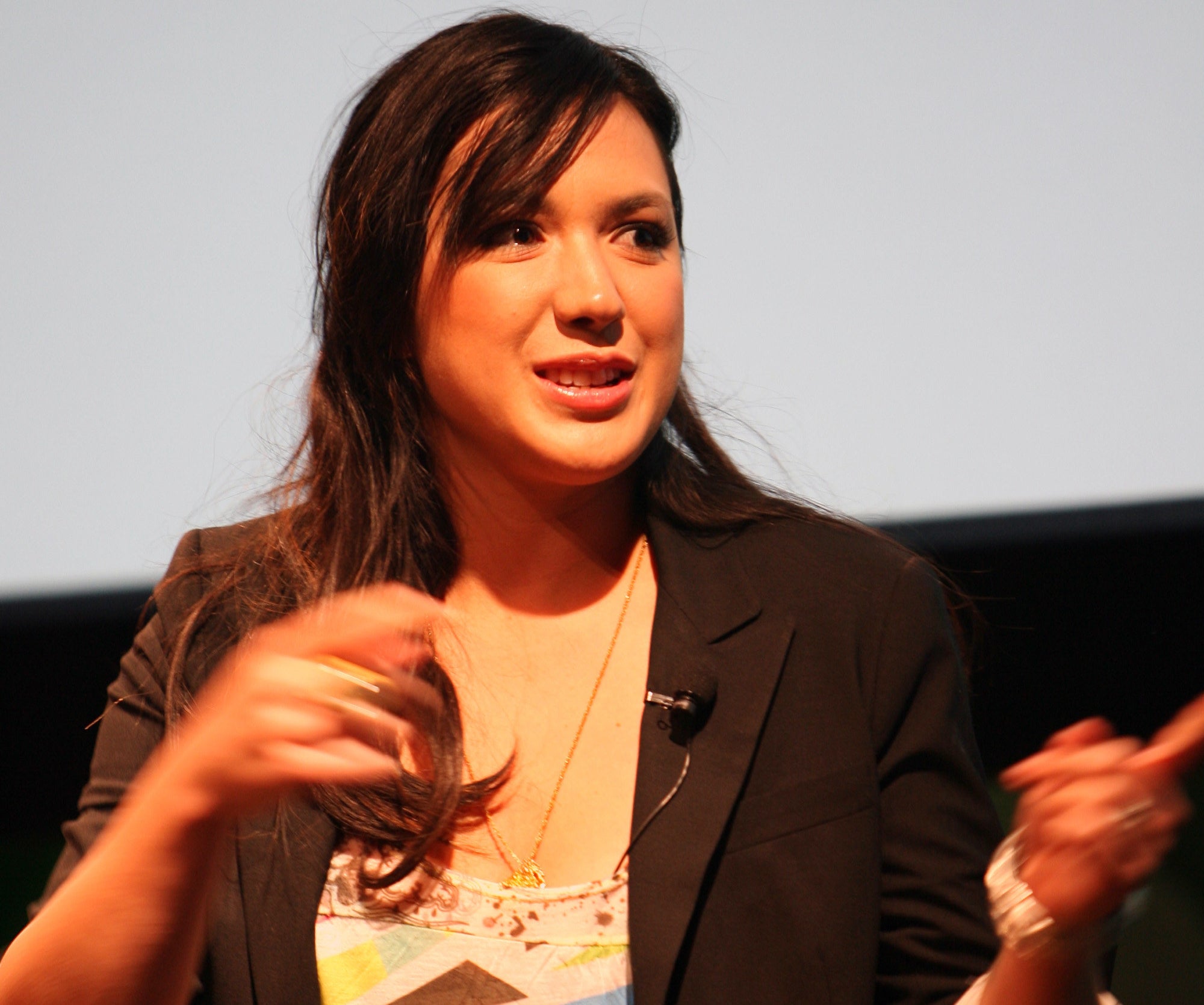 Michelle speaks on stage at an event