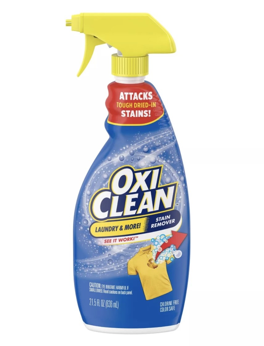The blue, yellow and red bottle says &quot;OXICLEAN&quot; and has a yellow shirt and bubbles on the design