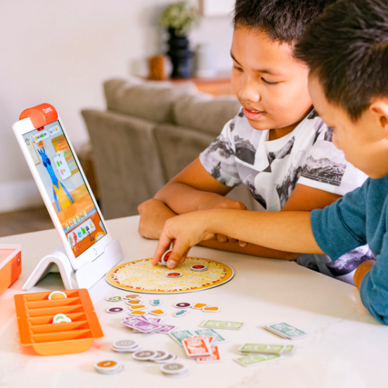 Two young boys playing with Osmo&#x27;s Pretend Play Bundle
