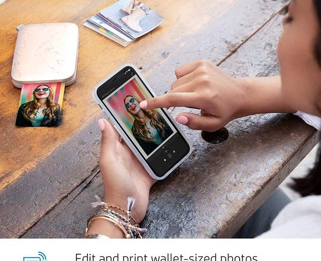 model showing how you can print a picture straight from the phone and it comes out in a small instant print size