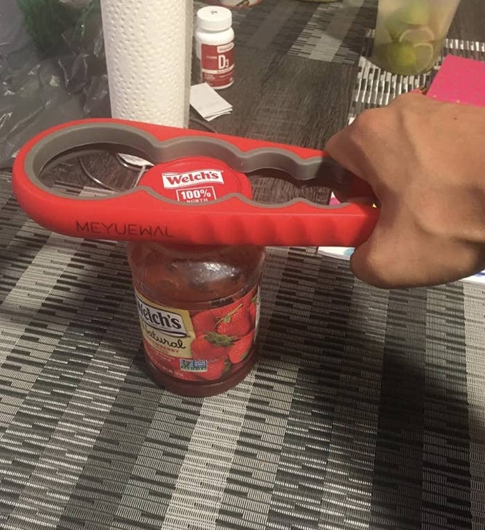 reviewer using the jar opener to open a jar of jam