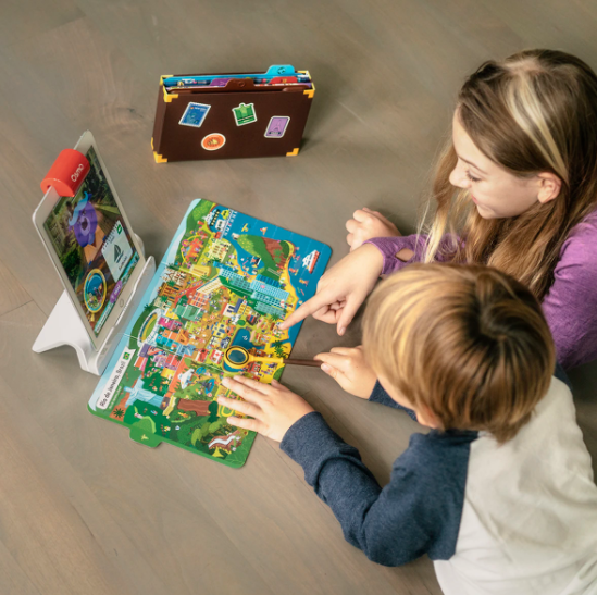 Two children playing with Osmo&#x27;s Super Osmonaut Starter Kit