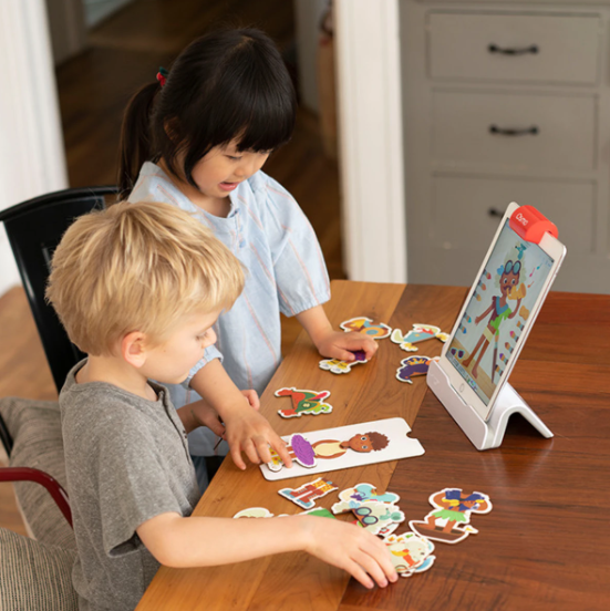 A young boy and young girl playing with Osmo&#x27;s Little Genius Starter Kit