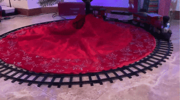 Reviewer GIF of the train running in a circle under a Christmas tree