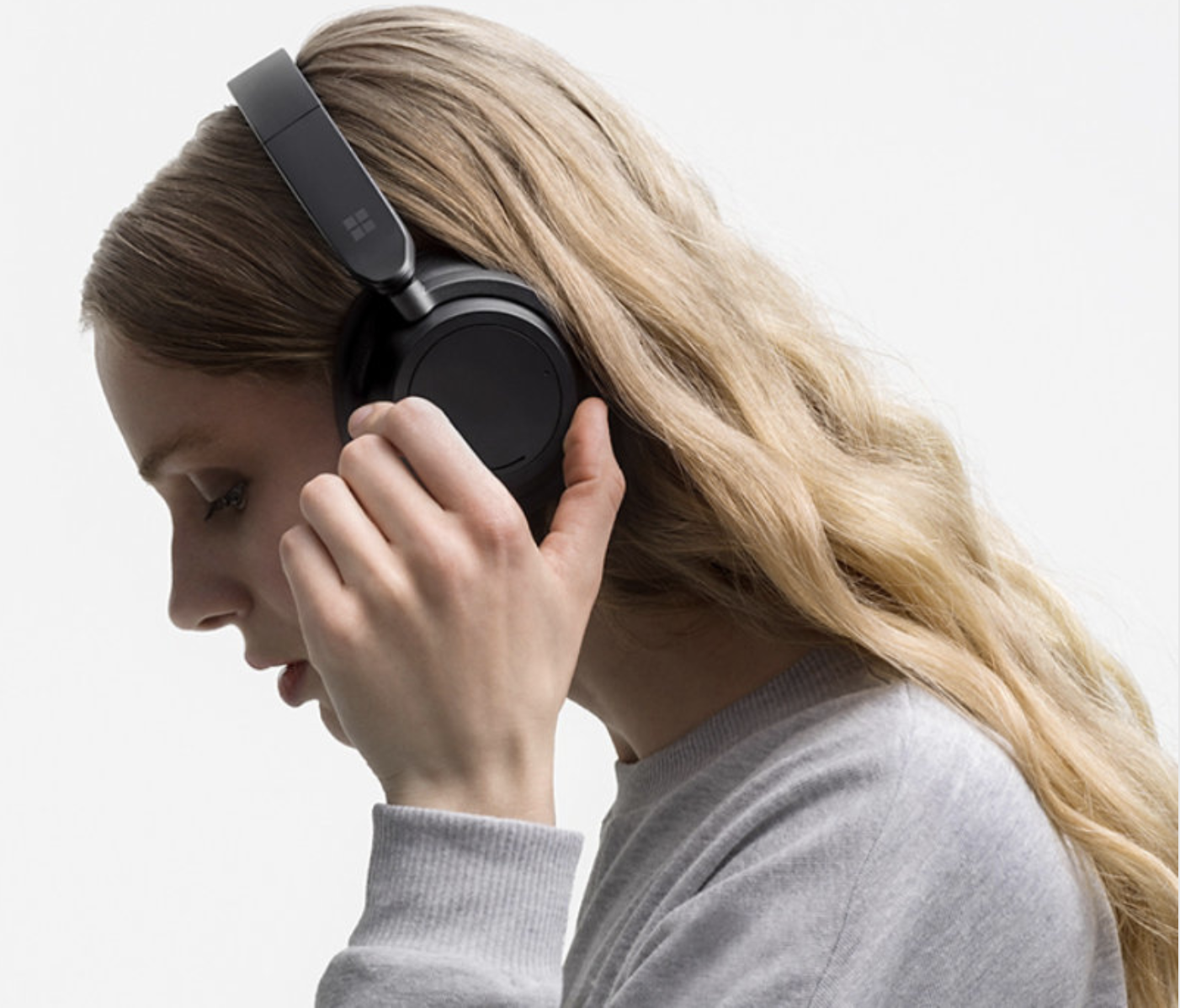 A model wearing the black over the ear headphones