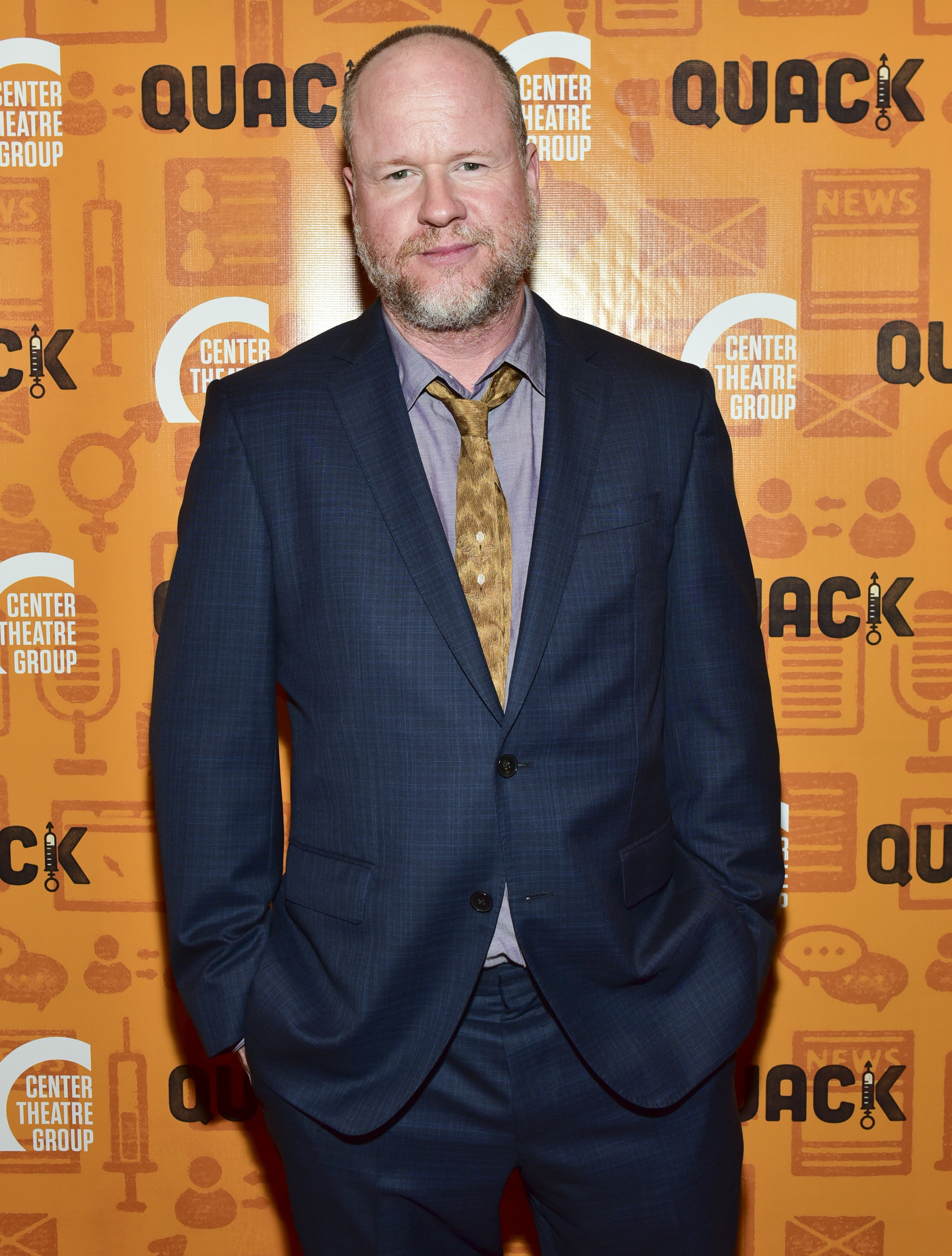 Joss Whedon posing on a red carpet