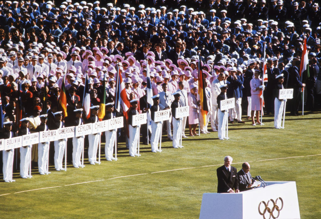 Closeup of teams on the field during the Opening Ceremonies for the XVIII Olympiad.