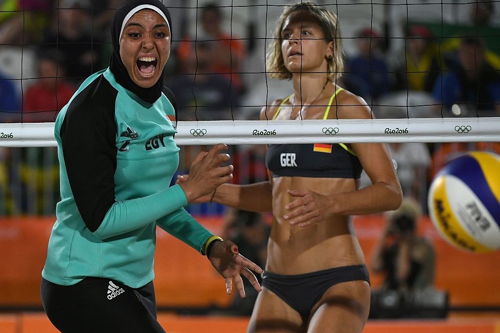 Germany&#x27;s Laura Ludwig (R) watches as Egypt&#x27;s Doaa Elghobashy reacts during the women&#x27;s beach volleyball qualifying match between Germany and Egypt at the Beach Volley Arena in Rio de Janeiro on August 7, 2016, for the Rio 2016 Olympic Games