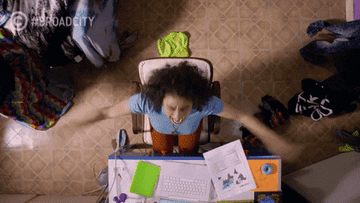gif of ilana in broad city looking up with arms outstretched screaming at a desk