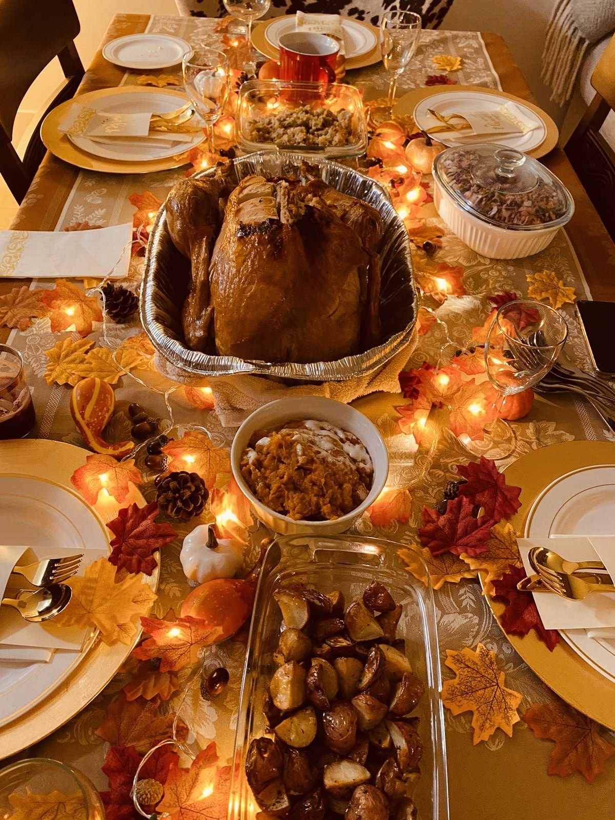 reviewer image of the light up maple leaves on a table with a turkey, potatoes, and other thanksgiving delicacies