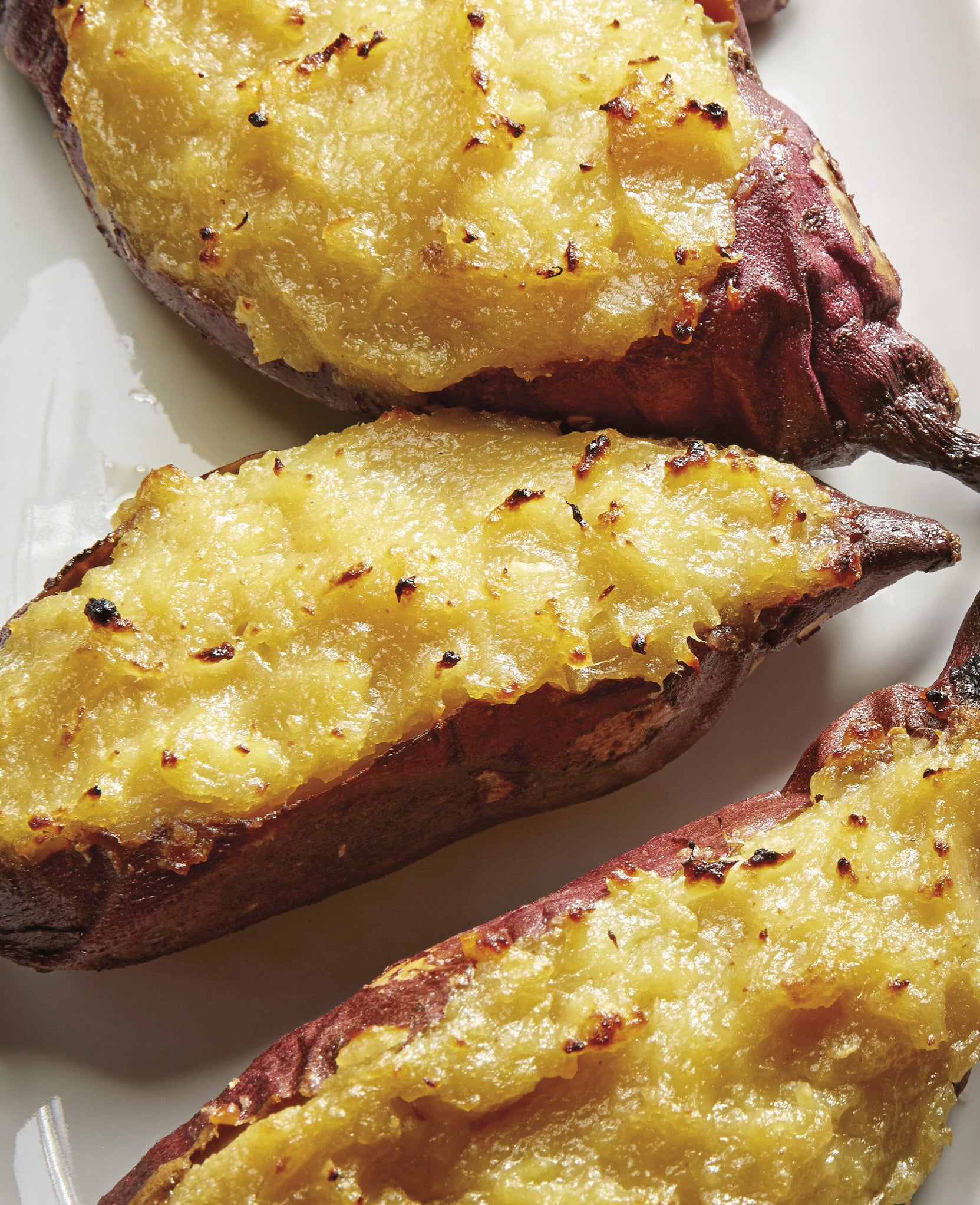 Twice-baked potatoes served on a white platter.