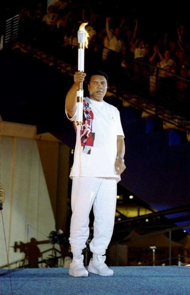 19 Jul 1996:  Muhammad Ali holds the torch before lighting the Olympic Flame during the Opening Ceremony of the 1996 Centennial Olympic Games in Atlanta, Georgia.