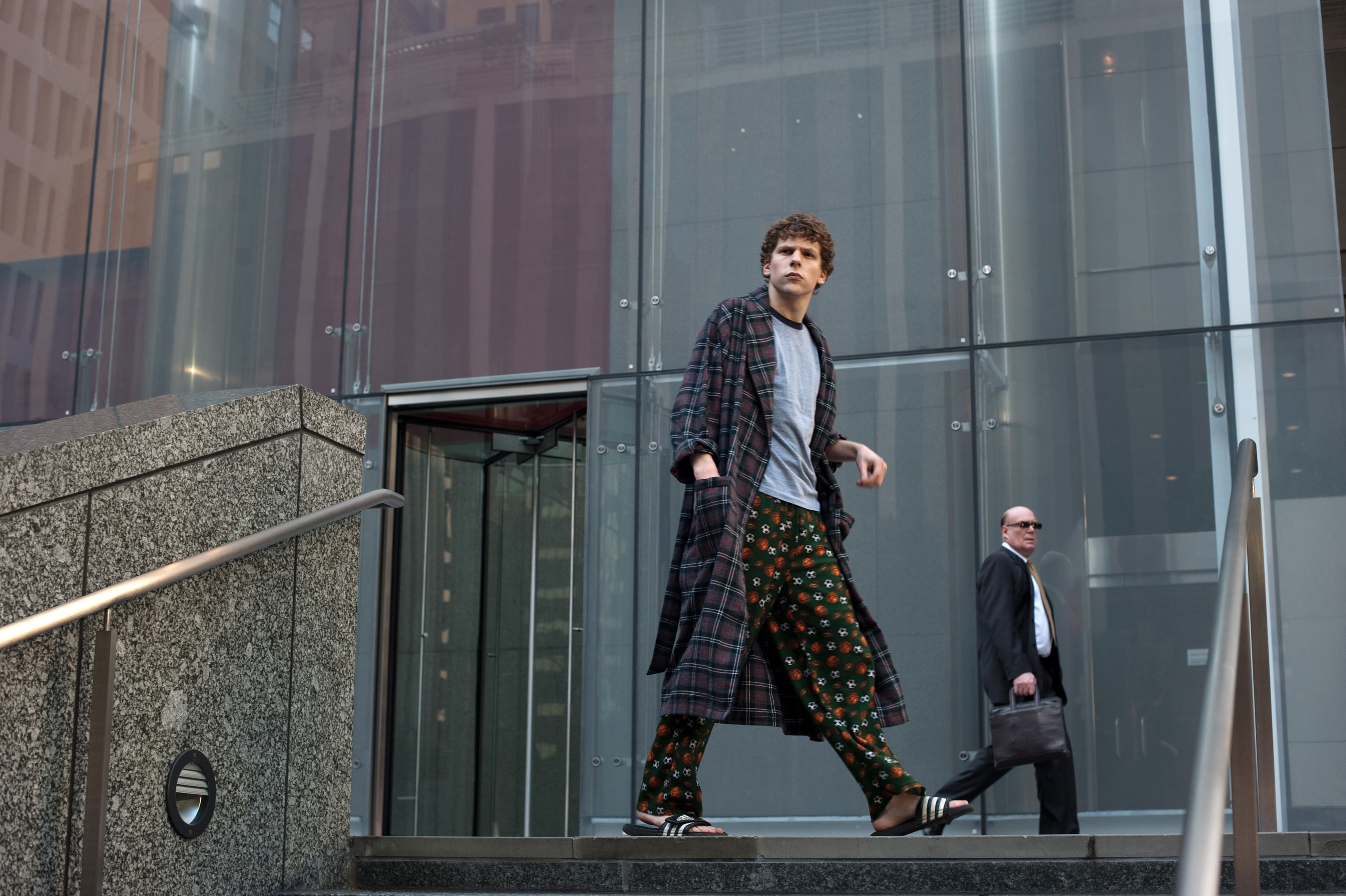 Zuckerberg walking across a corporate plaza in his pajamas