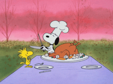 snoopy sharpening a carving knife before cutting into a turkey