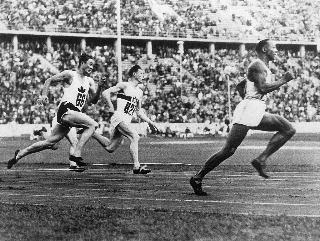 Berlin, Germany- Jesse Owens, is shown winning one of the 200-meter heats. L. Orr of Canada is second and K. Neckermann of Germany, third. Owens bettered the Olympic record with his time of 21.1. The former record of 21.2 was made by Eddie Tolan in 1932.