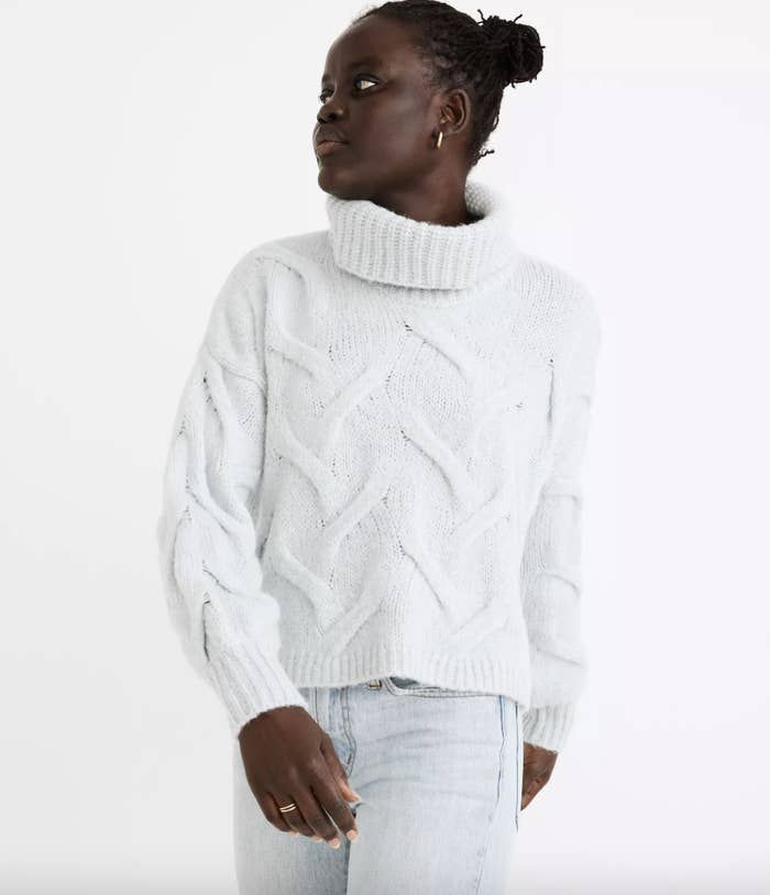 model wearing the white sweater