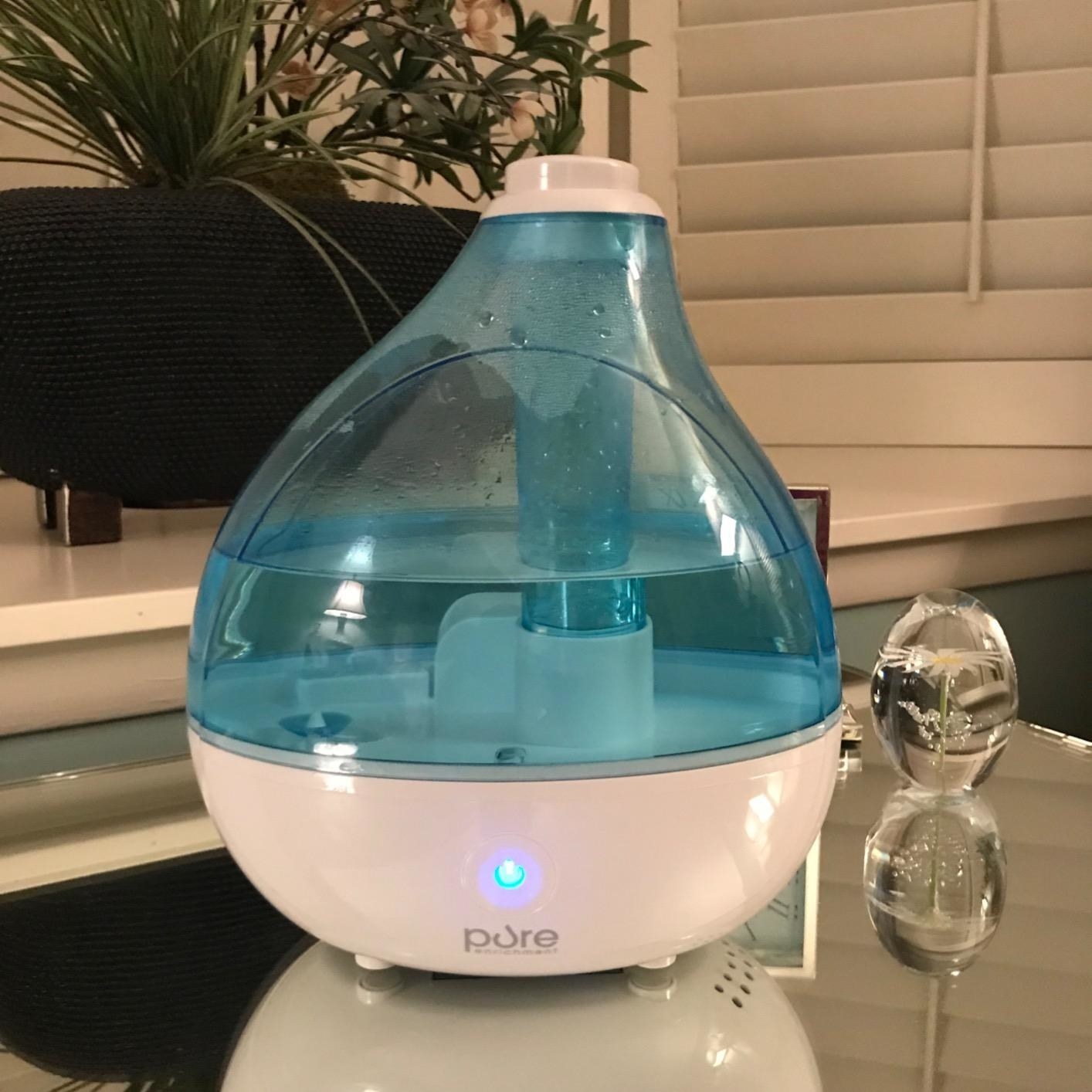 the humidifier filled with water sitting on a desk