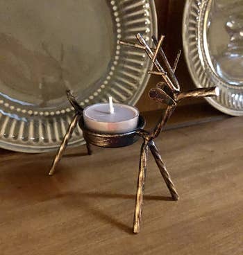 Reviewer photo of the reindeer tealight holder holding an unlit candle
