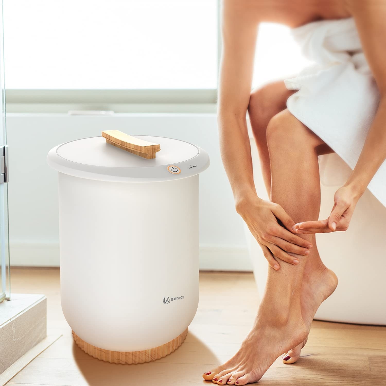 someone sitting next to the cylindrical towel warmer