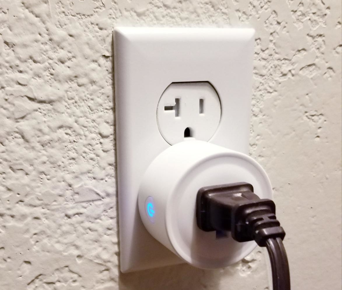 a reviewer photo of the smart outlet plugged into a wall outlet with a cord plugged in
