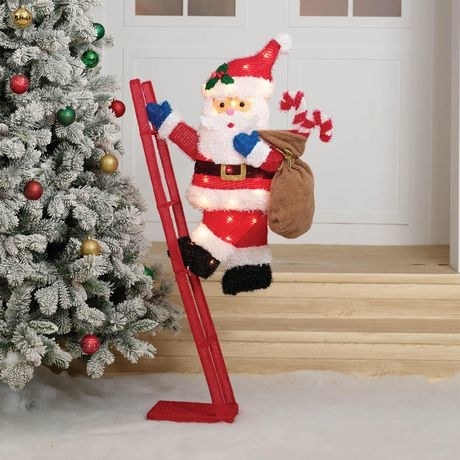 Santa toy climbing up a ladder next to a Christmas tree