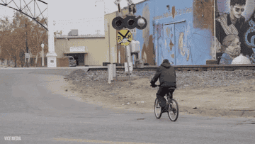 A person riding a bike into the distance