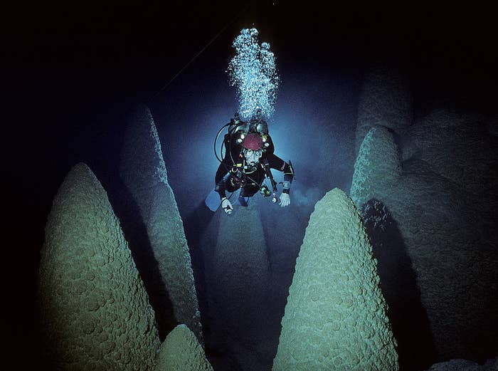 Phil Dotchon swims between mysterious cone-like underwater formations in Mimoso Cave