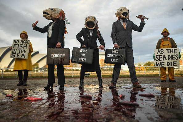 Protesters wearing fish-head costumes