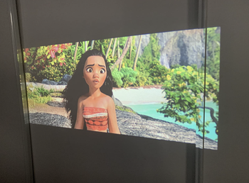 A customer review photo of a movie being projected onto their wall