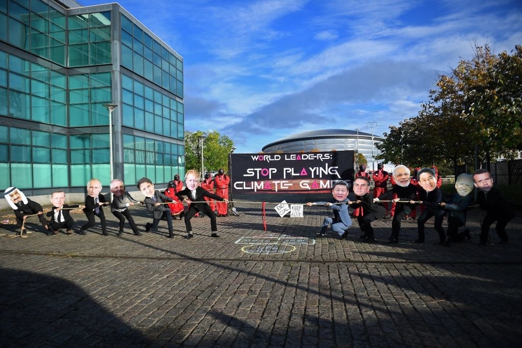 Protesters in masks playing Tug Of War