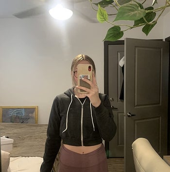 reviewer mirror selfie waring black cropped hoodie