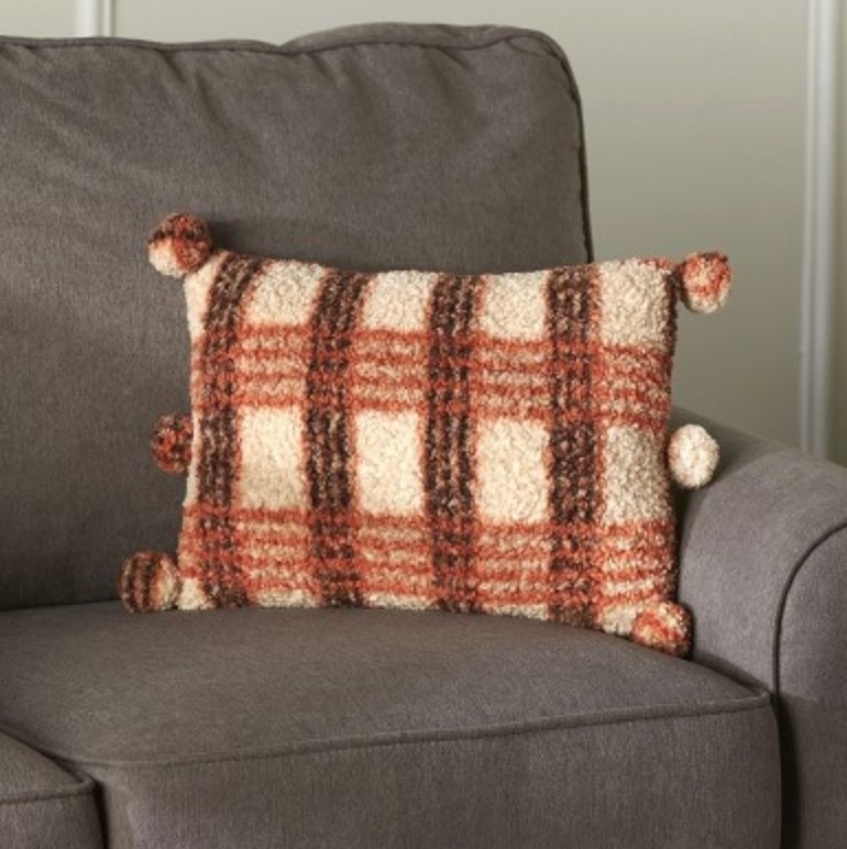 The orange and brown Sherpa throw pillow