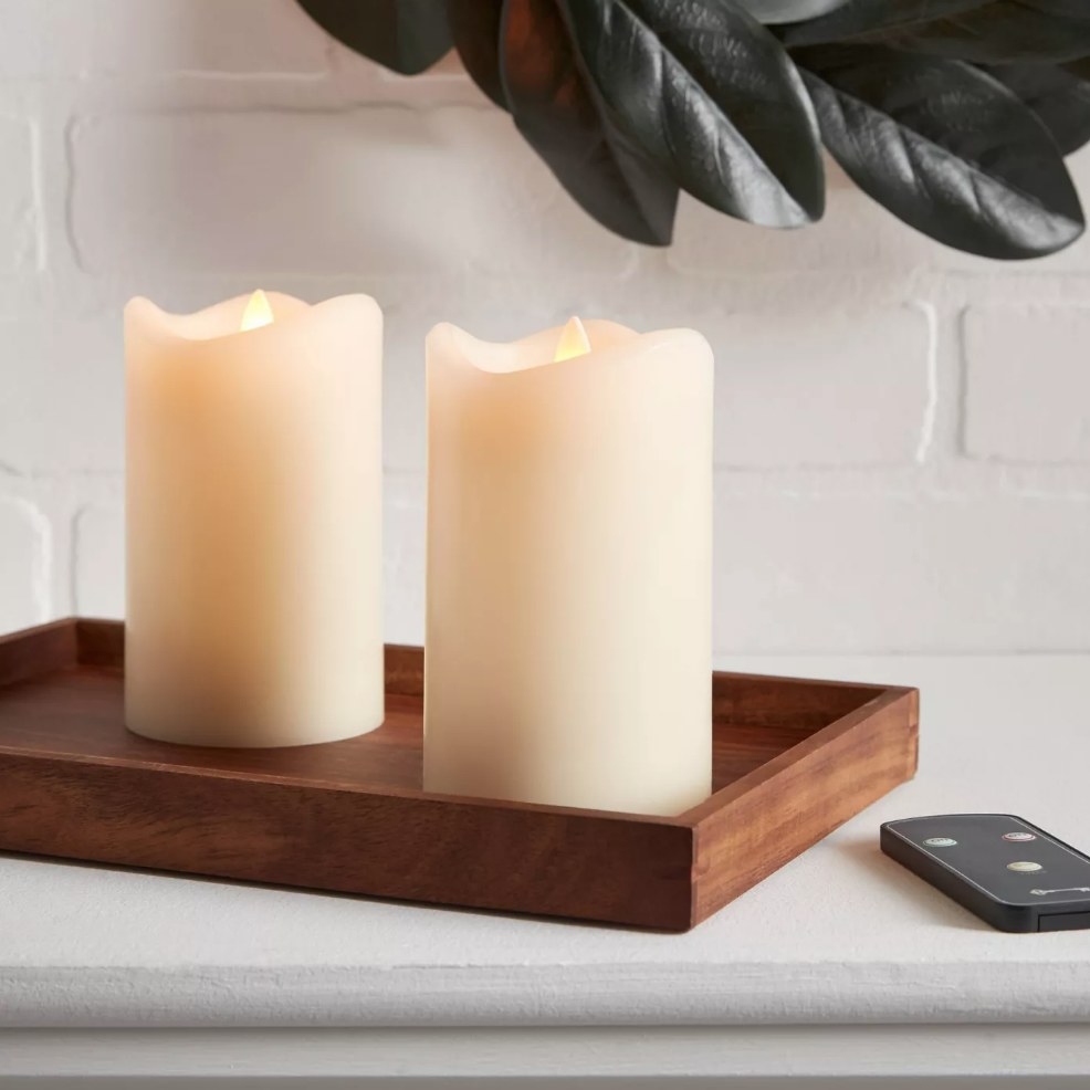 Two cream colored faux candles