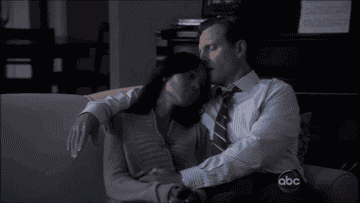 Fitz and Olivia cuddling on her couch